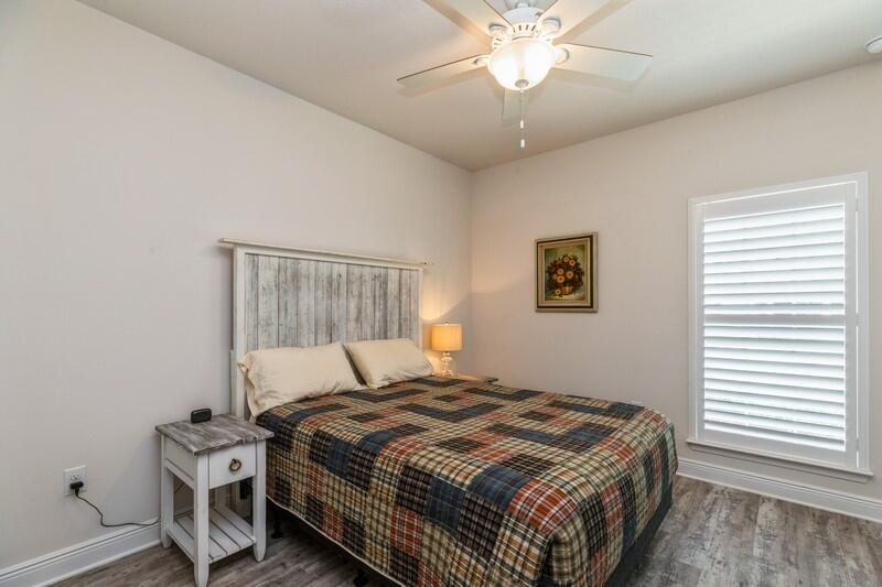 288 Conner Circle Santa Rosa Beach, FL 32459 - Photo 23 of 37 a bedroom with a bed and a chandelier