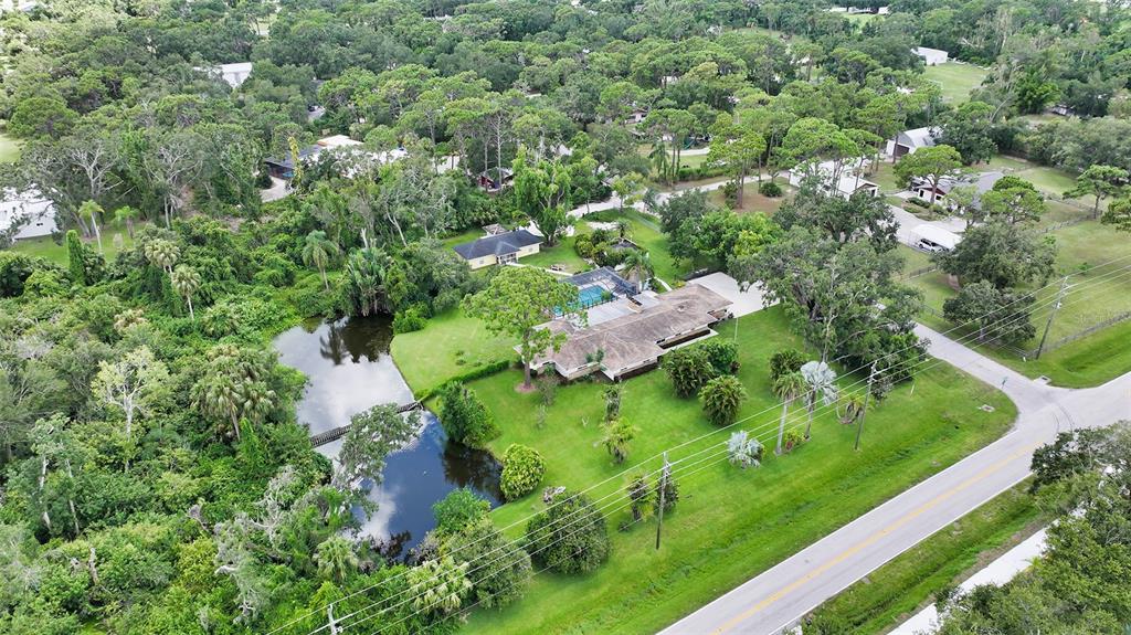 3012 Desoto Road Sarasota, FL 34234 - Photo 1 of 78 an aerial view of residential house with outdoor space and trees all around
