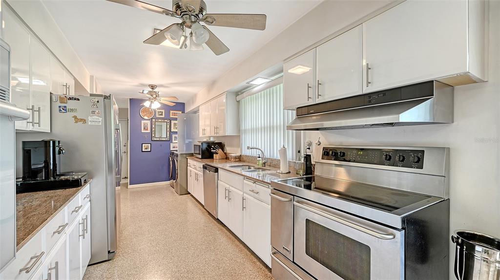 3012 Desoto Road Sarasota, FL 34234 - Photo 29 of 78 a kitchen with stainless steel appliances granite countertop a stove a refrigerator and a microwave