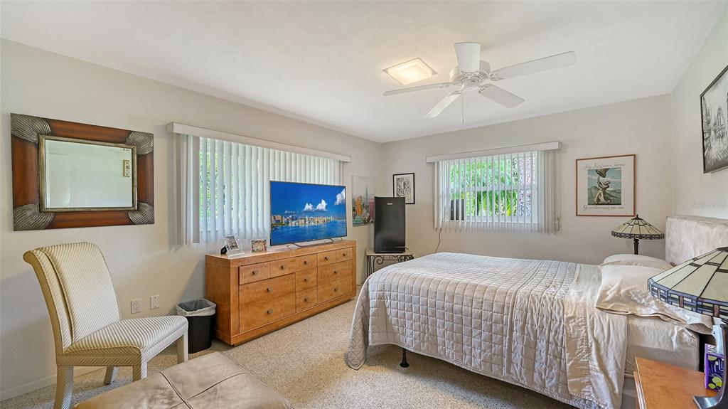 3012 Desoto Road Sarasota, FL 34234 - Photo 41 of 78 a bedroom with a bed and a chair