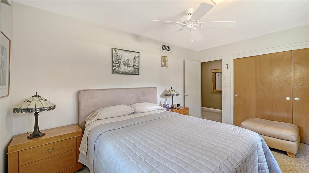 3012 Desoto Road Sarasota, FL 34234 - Photo 42 of 78 a bedroom with a bed and a chandelier