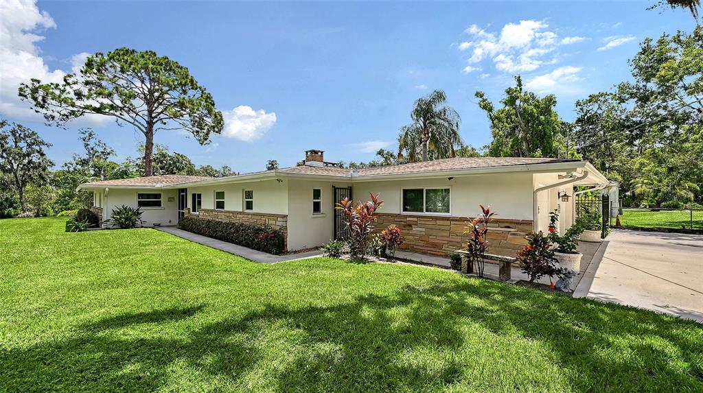 3012 Desoto Road Sarasota, FL 34234 - Photo 8 of 78 a front view of house with a garden and patio
