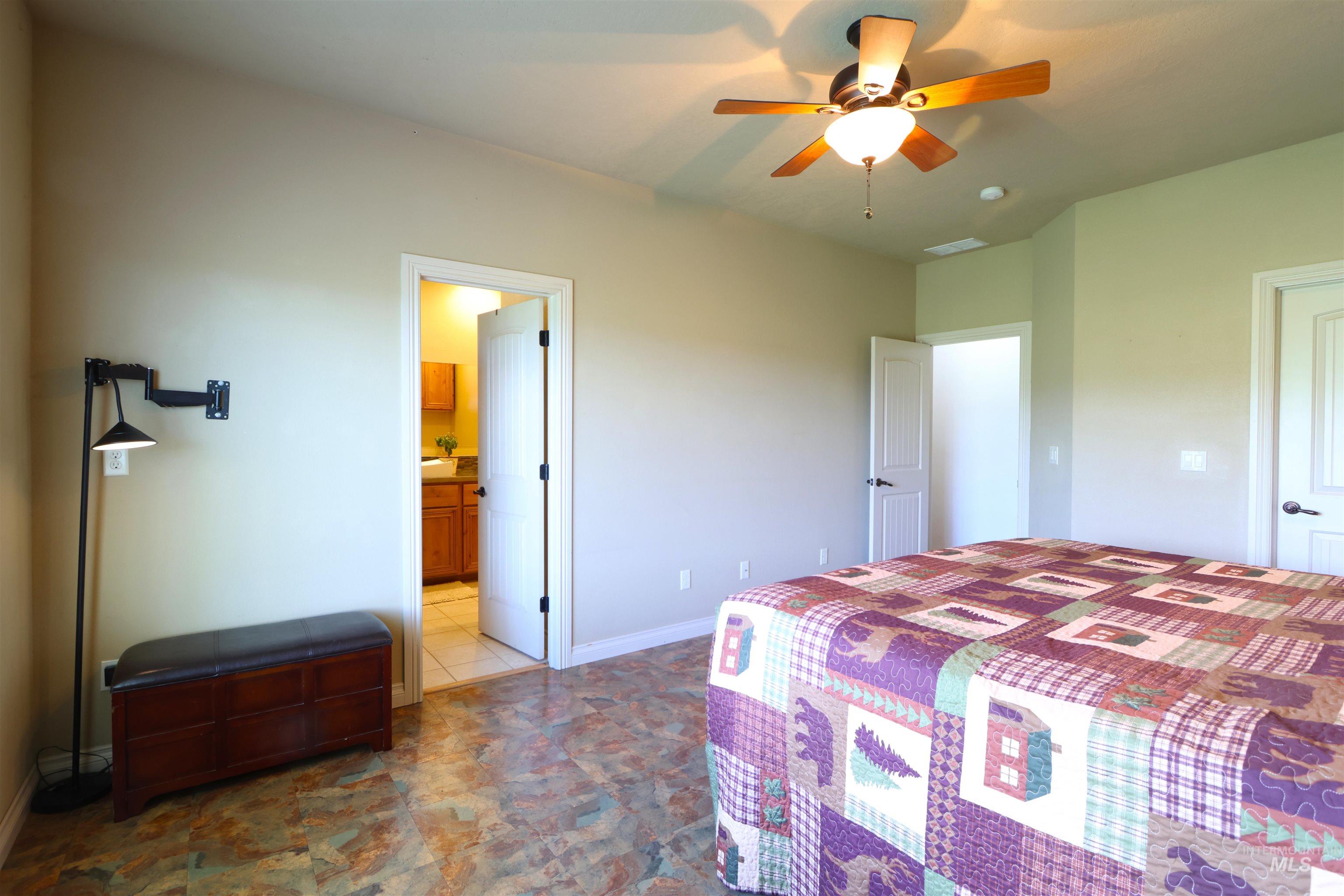 2278 Golf Lane Council, ID 83612 - Photo 11 of 31 Spacious room featuring multi-toned tile flooring, a ceiling fan with integrated lighting, and a neutral wall color