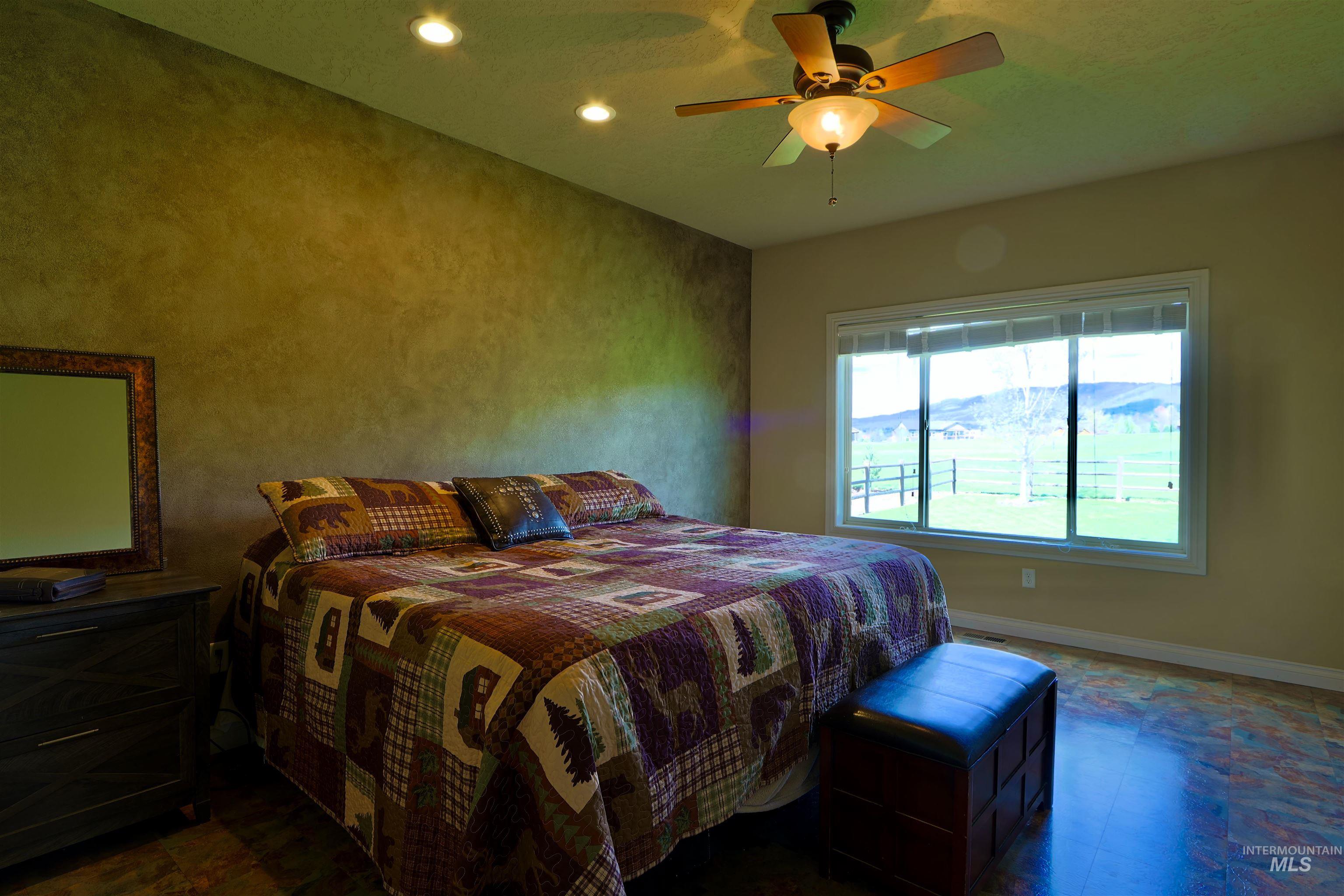 2278 Golf Lane Council, ID 83612 - Photo 12 of 31 Interior room featuring a large window, a ceiling fan with integrated lighting, recessed ceiling lights, and wood-finish flooring