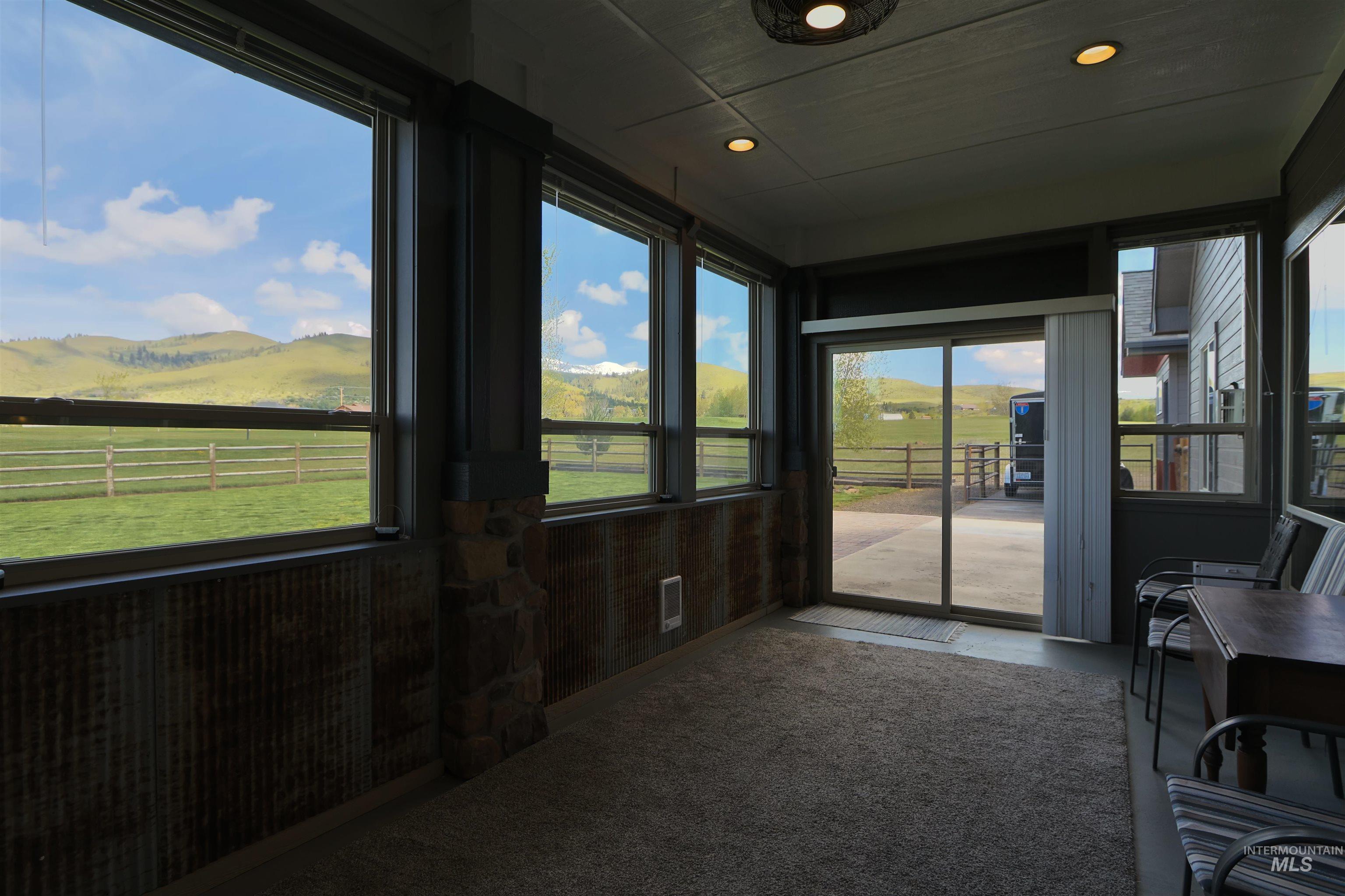 2278 Golf Lane Council, ID 83612 - Photo 20 of 31 Screened porch featuring extensive windows, a sliding glass door, recessed lighting, and carpeted flooring
