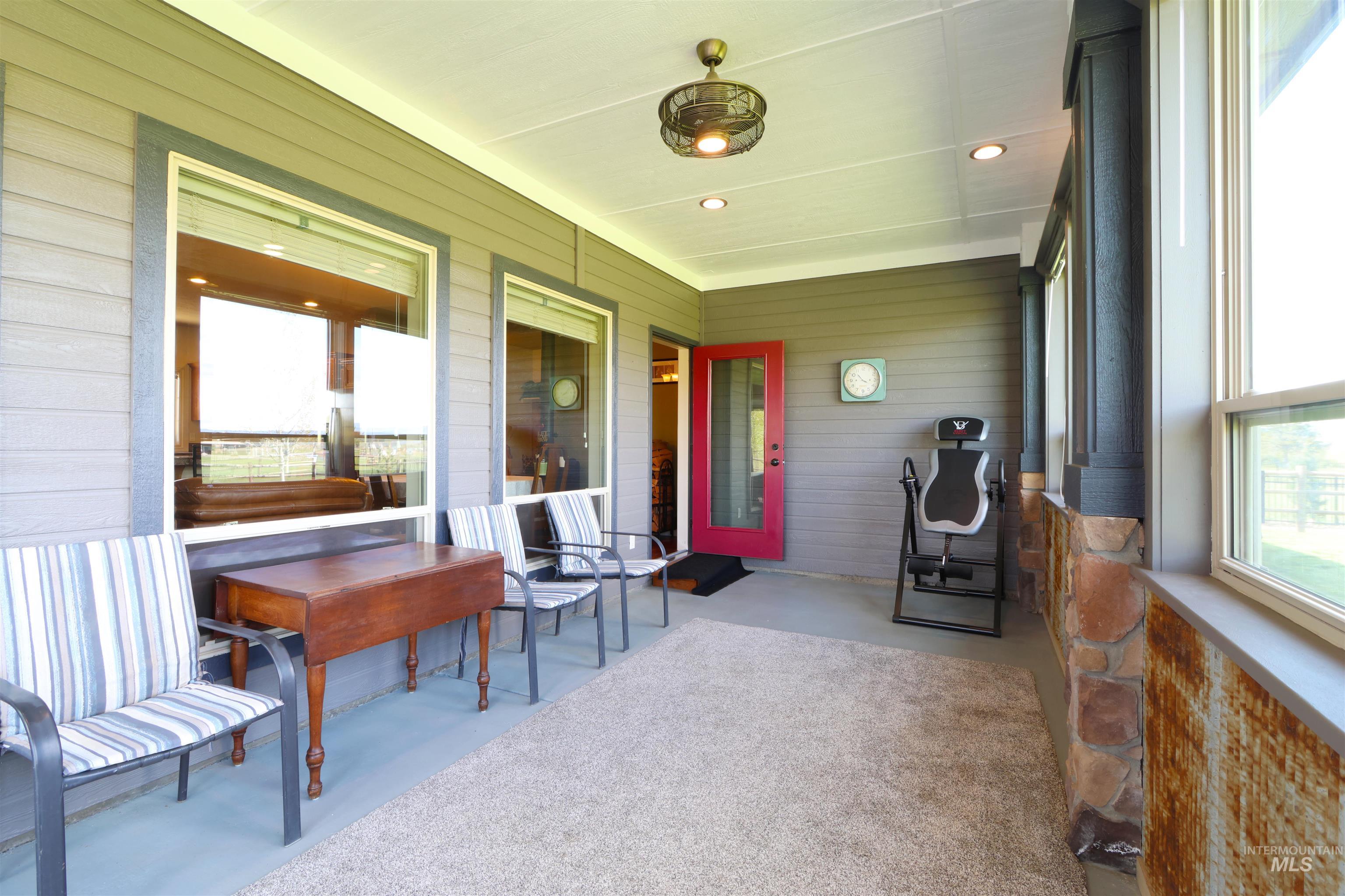 2278 Golf Lane Council, ID 83612 - Photo 21 of 31 Covered patio featuring plank siding, stone accents, recessed lighting, and a ceiling fan