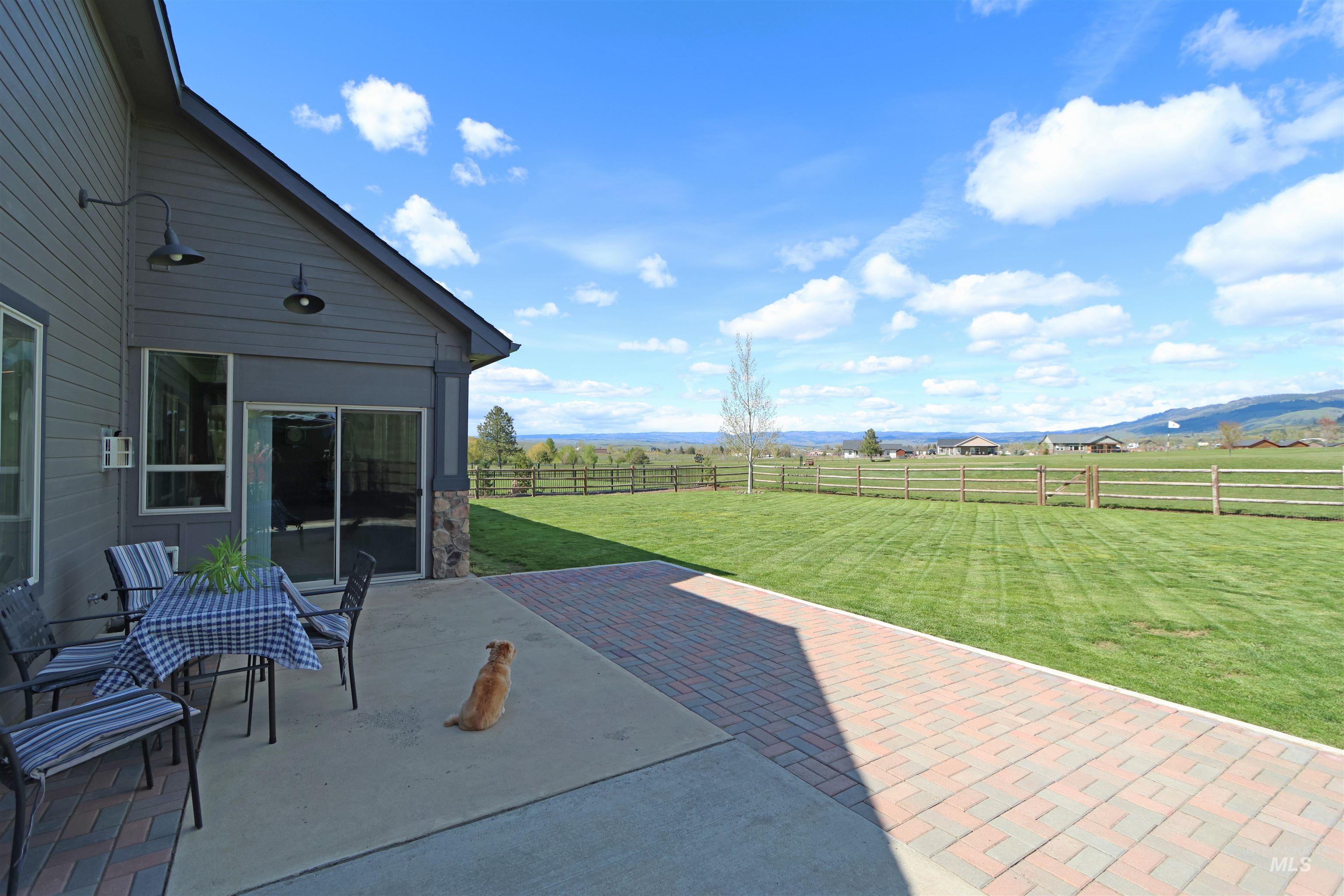 2278 Golf Lane Council, ID 83612 - Photo 23 of 31 Expansive brick paver patio with a concrete section, offering access to the interior via a glass slider