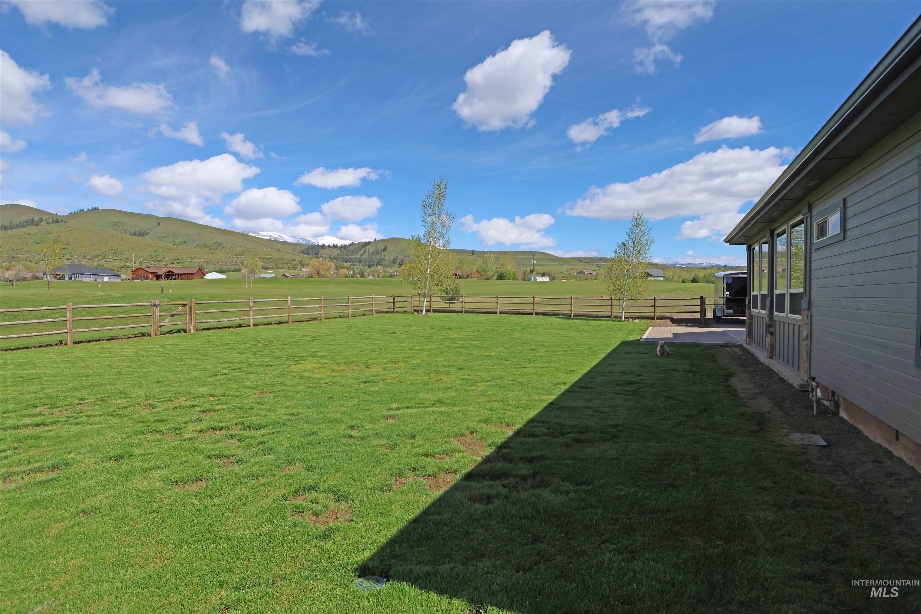 2278 Golf Lane Council, ID 83612 - Photo 25 of 31 Expansive green lawn with a split rail fence bordering the property