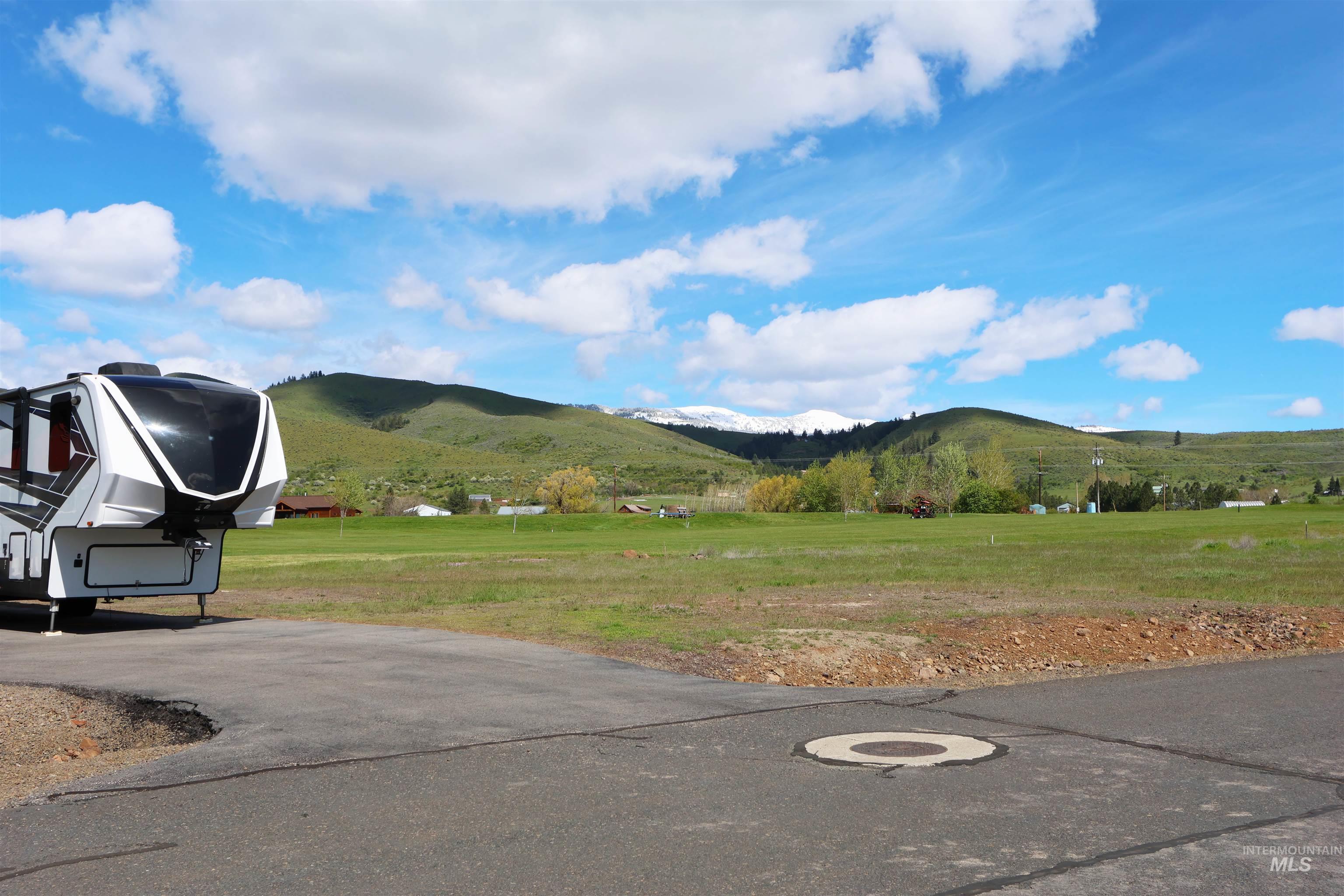 2278 Golf Lane Council, ID 83612 - Photo 27 of 31 Paved lot with partial landscaping, featuring distant snow-capped mountains and green hills