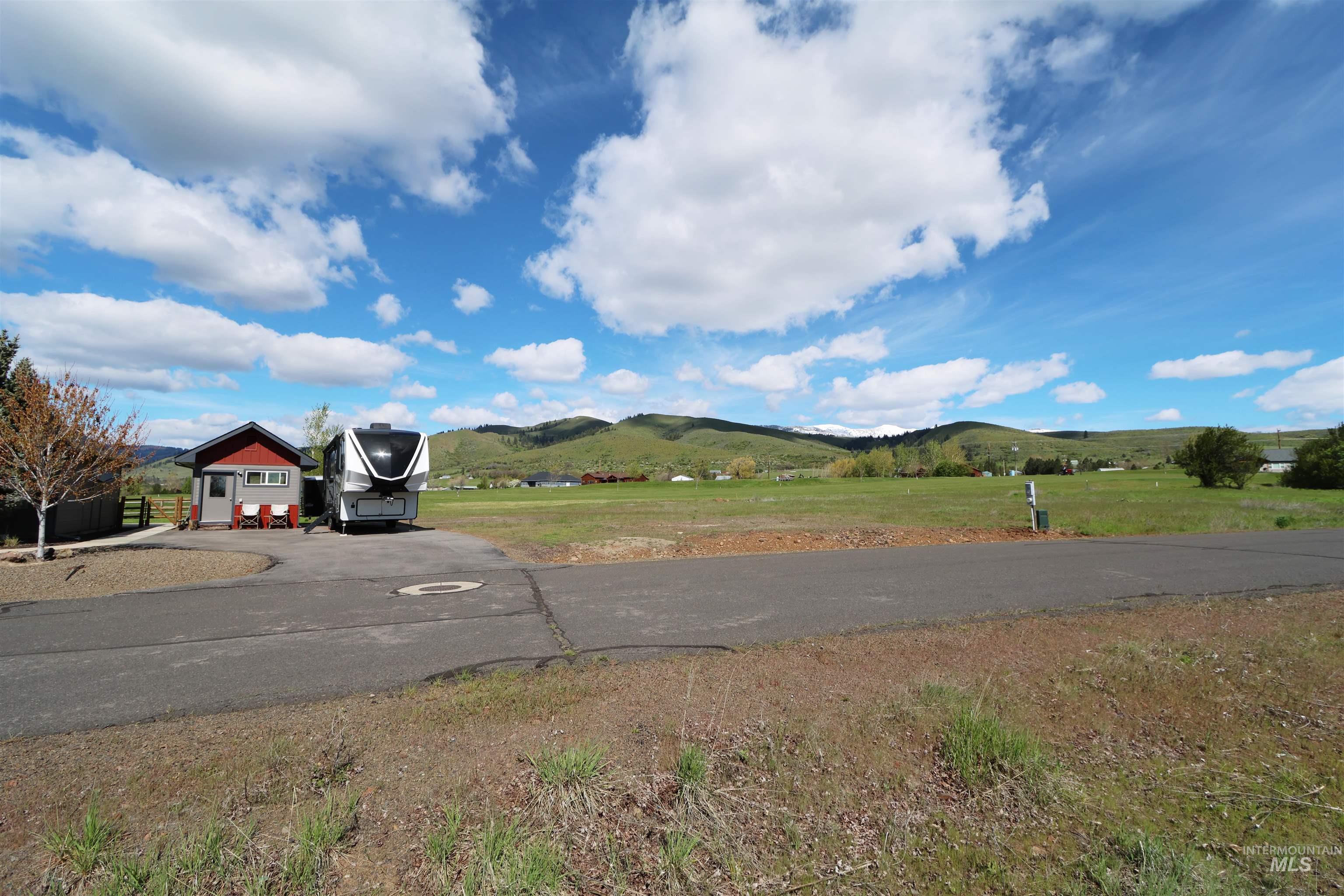 2278 Golf Lane Council, ID 83612 - Photo 29 of 31 Paved driveway with a gravel border, providing access to a small structure and an adjacent RV parking area
