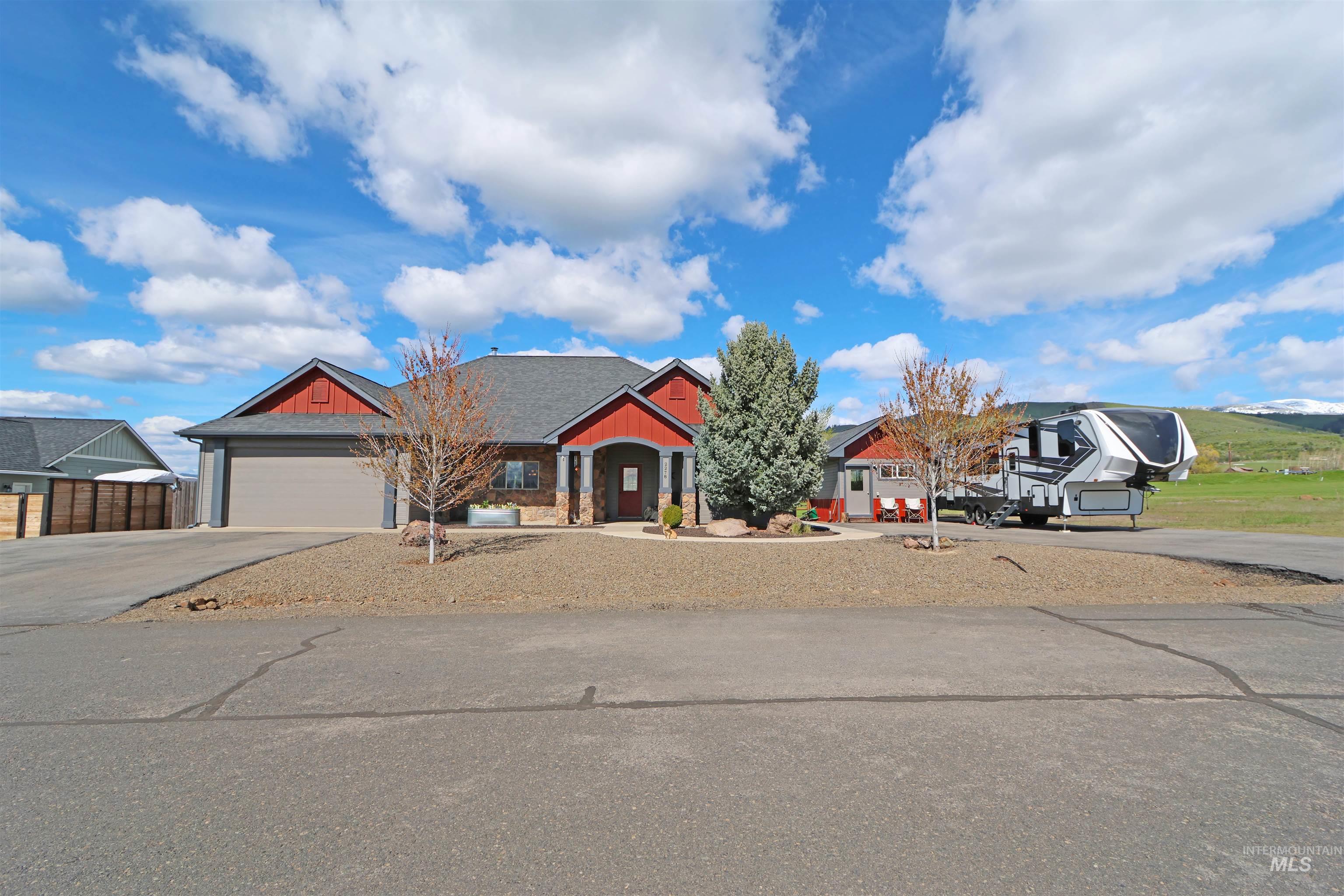 2278 Golf Lane Council, ID 83612 - Photo 31 of 31 Ranch-style residence featuring a gray shingle roof, red siding accents, and stone facade