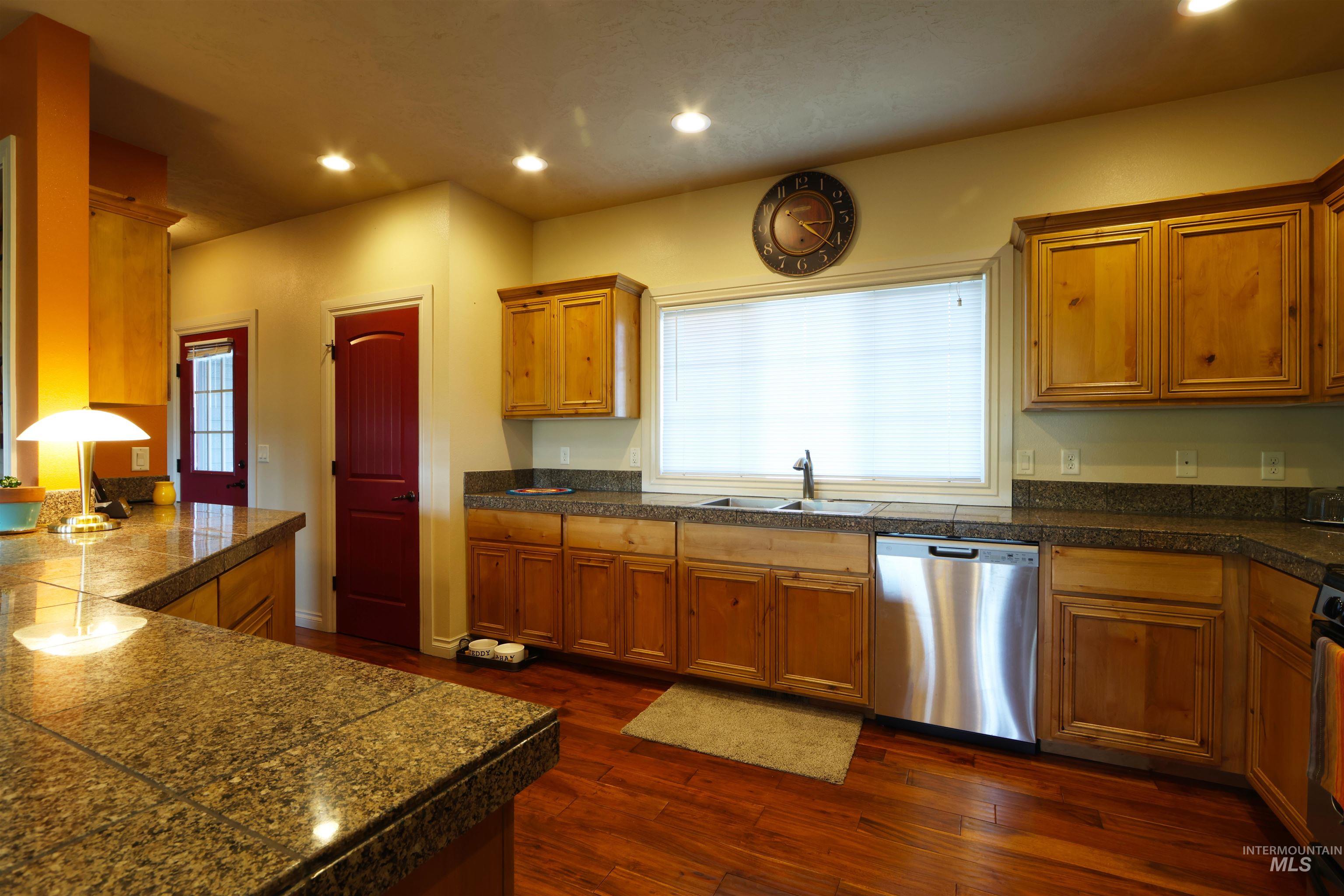 2278 Golf Lane Council, ID 83612 - Photo 8 of 31 Kitchen featuring wood-finish flooring, granite countertops, natural wood cabinetry, recessed lighting, and a stainless steel dishwasher