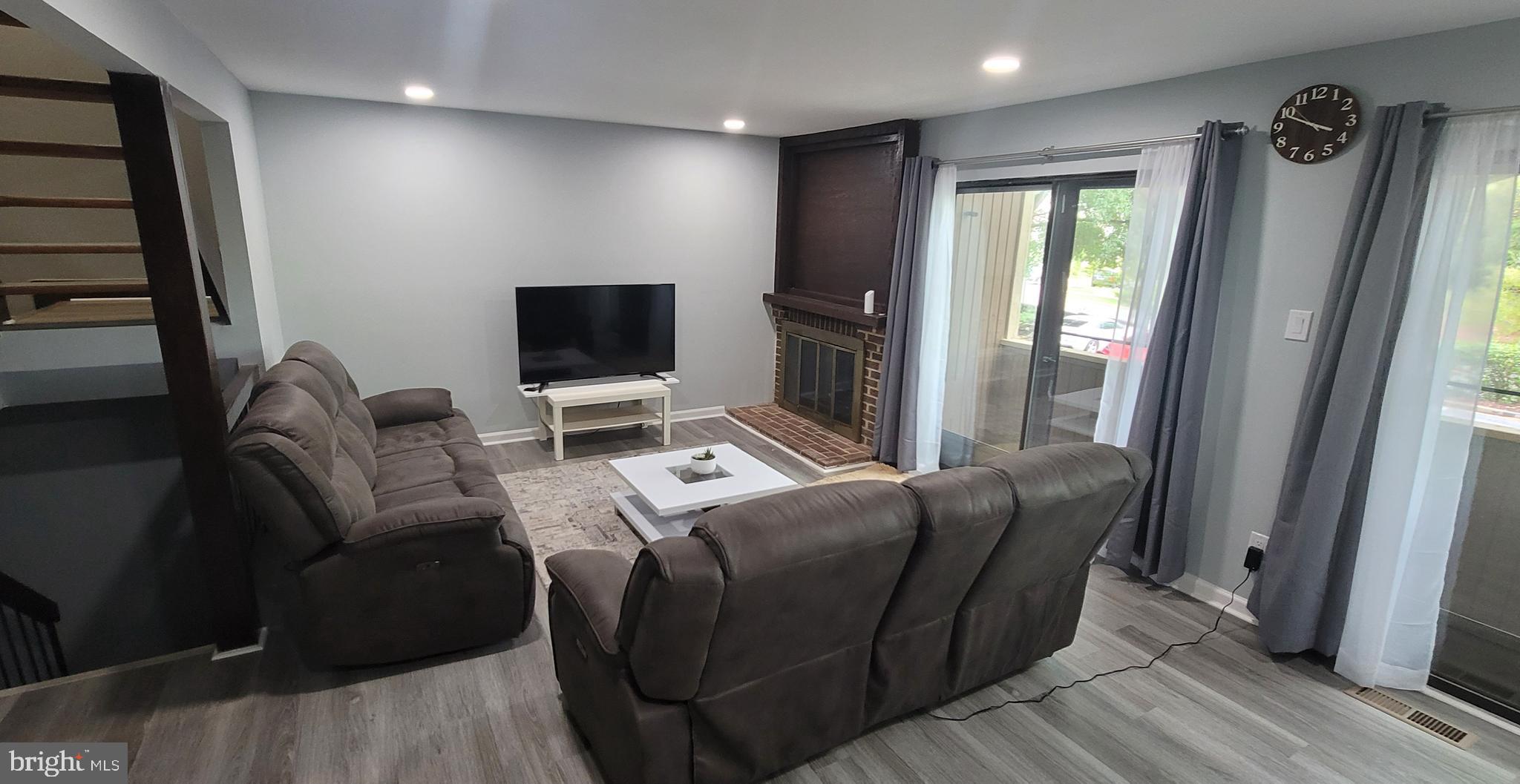 18420 Point Seneca Place, Unit BEDROOM 2 Germantown, MD 20874 - Photo 2 of 6 a living room with furniture and a flat screen tv