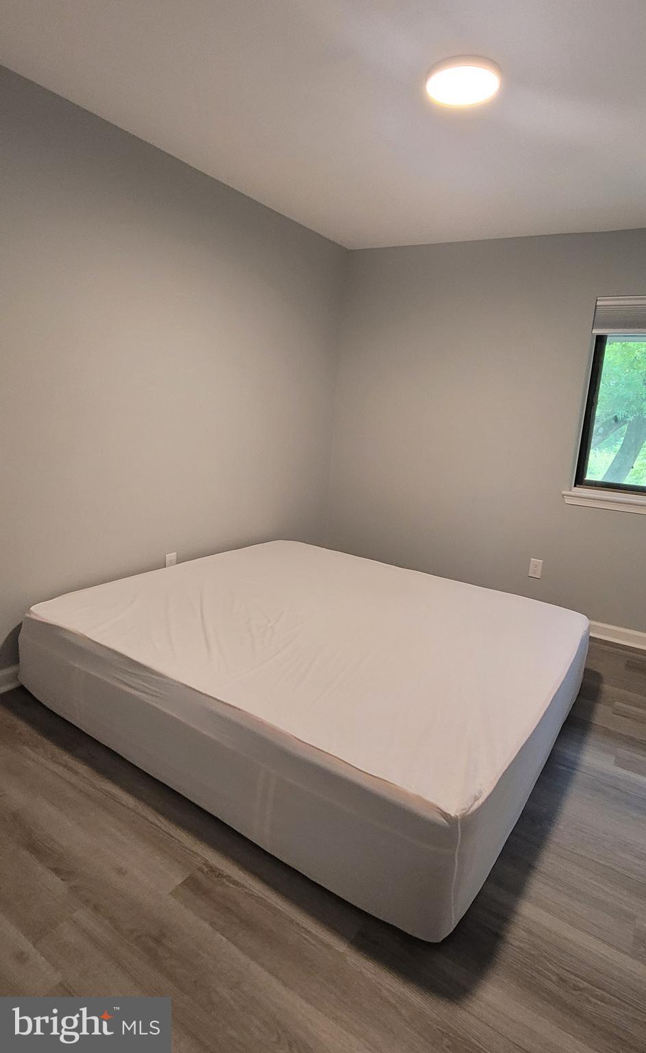 18420 Point Seneca Place, Unit BEDROOM 2 Germantown, MD 20874 - Photo 4 of 6 a bed sitting in a bedroom next to a window