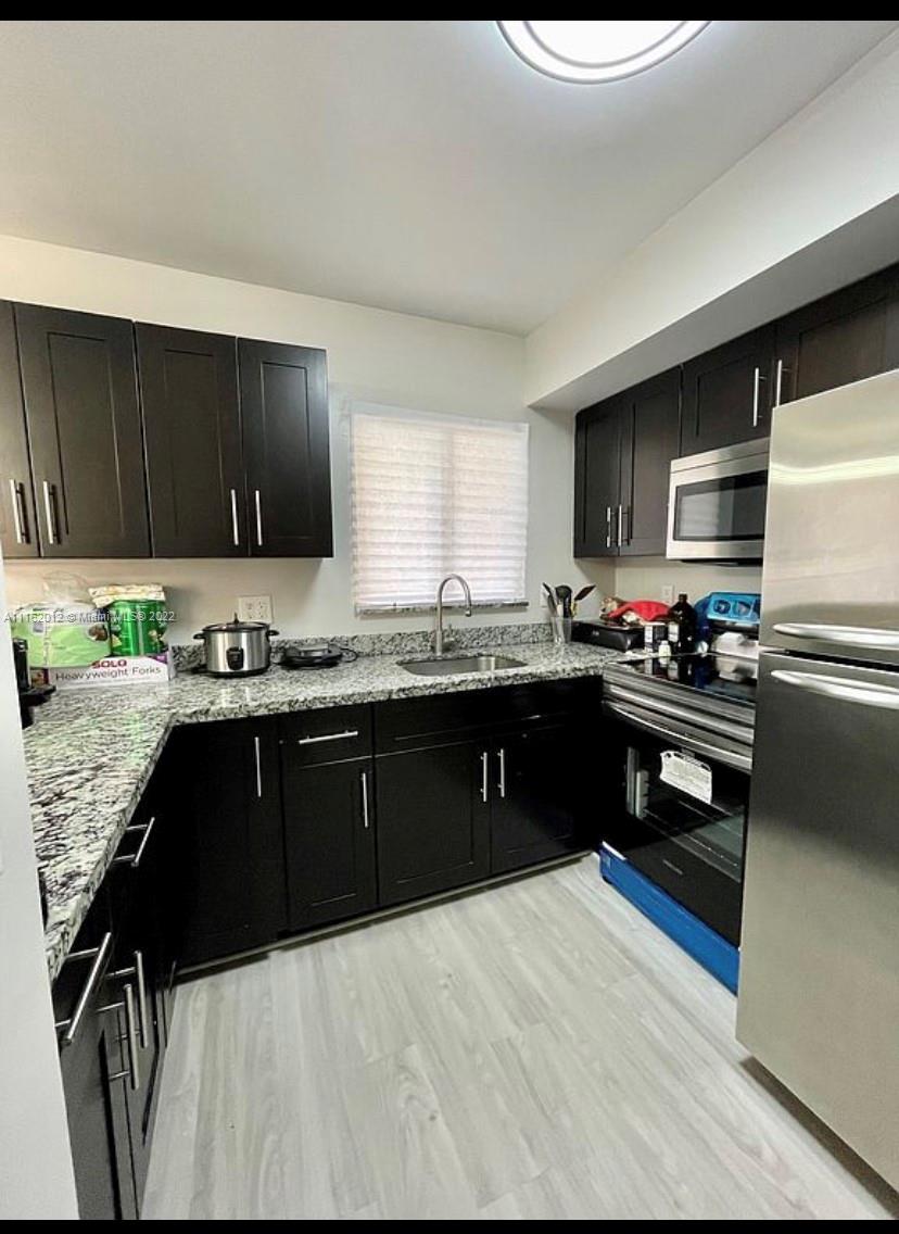 Kendale Lakes Miami, FL 33183 - Photo 2 of 9 a kitchen with granite countertop a refrigerator and a stove top oven
