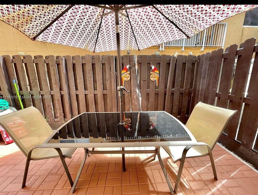 Kendale Lakes Miami, FL 33183 - Photo 3 of 9 a view of balcony with wooden floor and outdoor seating