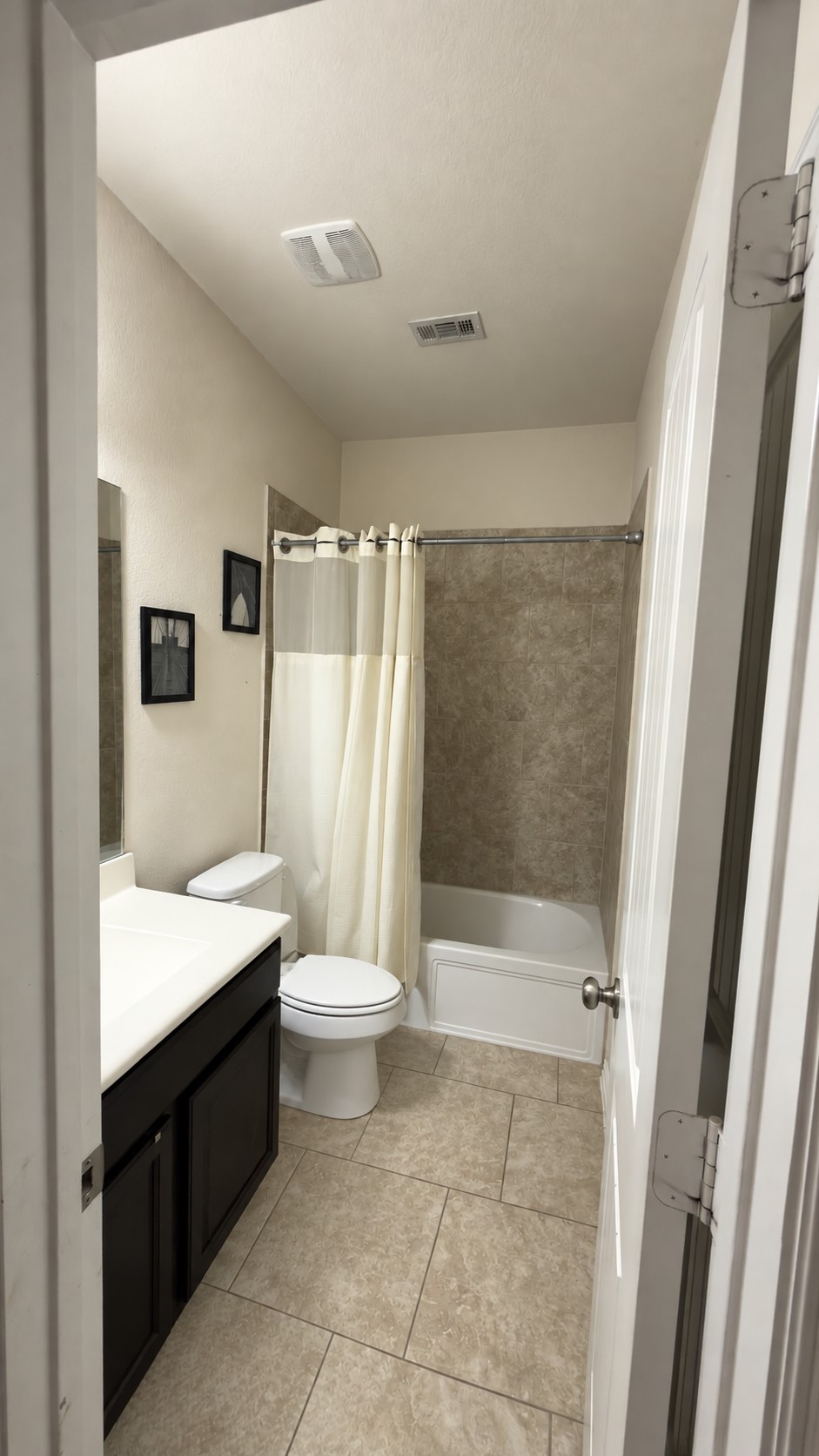 2500 Rough Berry Road Pflugerville, TX 78660 - Photo 12 of 15 Elegantly tiled floors complement a classic alcove bathtub setup in this sleek guest bath.