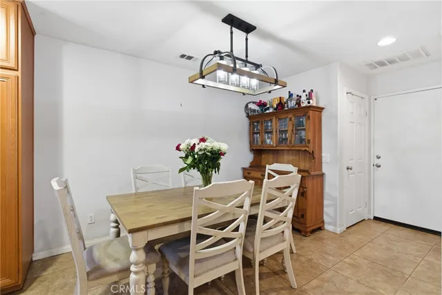 a view of a dining room with furniture and chandelier