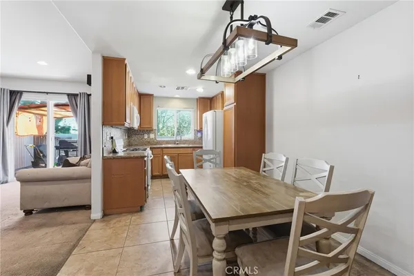 a view of a dining room with furniture and a chandelier