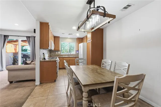 a view of a dining room with furniture and a chandelier