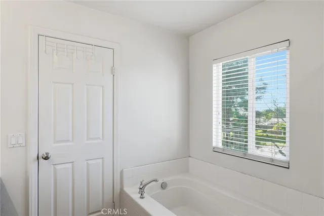 a white bath tub sitting next to a window