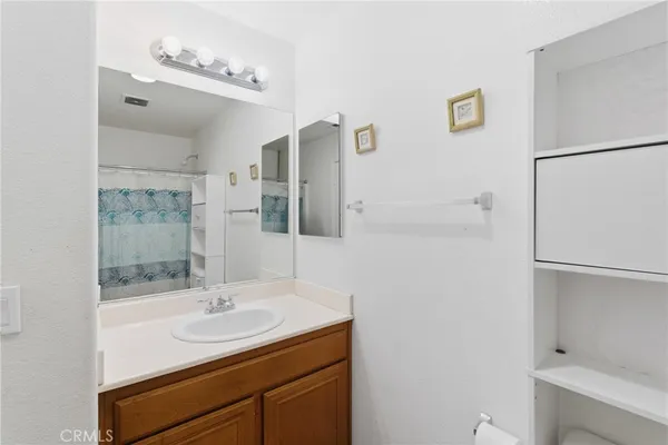 a bathroom with a sink mirror and shower