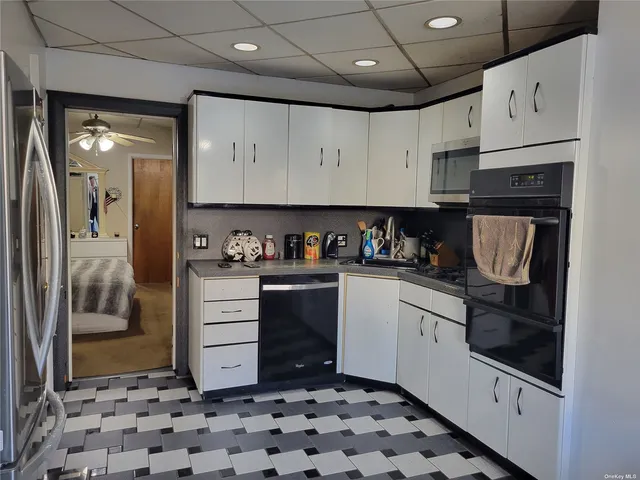 a kitchen with granite countertop a refrigerator and a sink