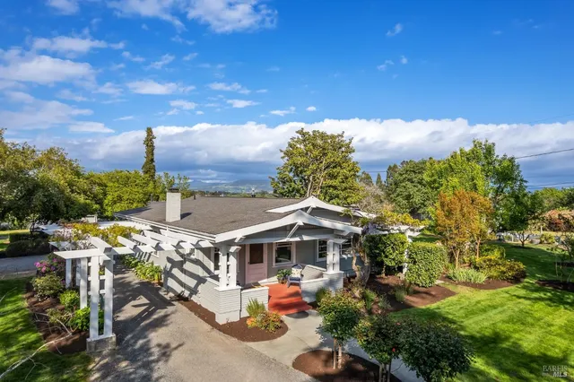 a view of a house with a yard and sitting area