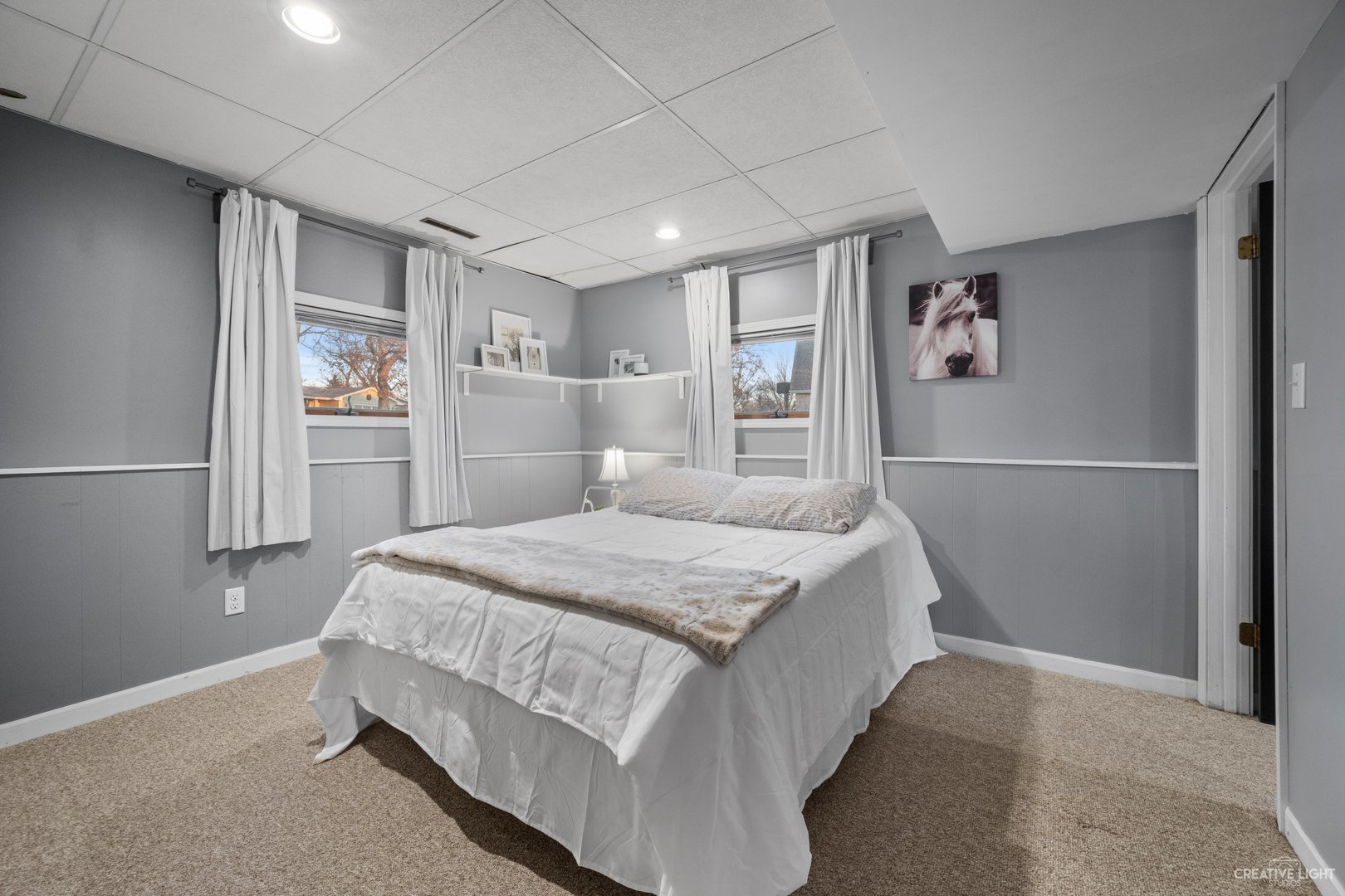 4S064 Thornapple Tree Road Sugar Grove, IL 60554 - Photo 28 of 39 a bedroom with a large bed and a chandelier