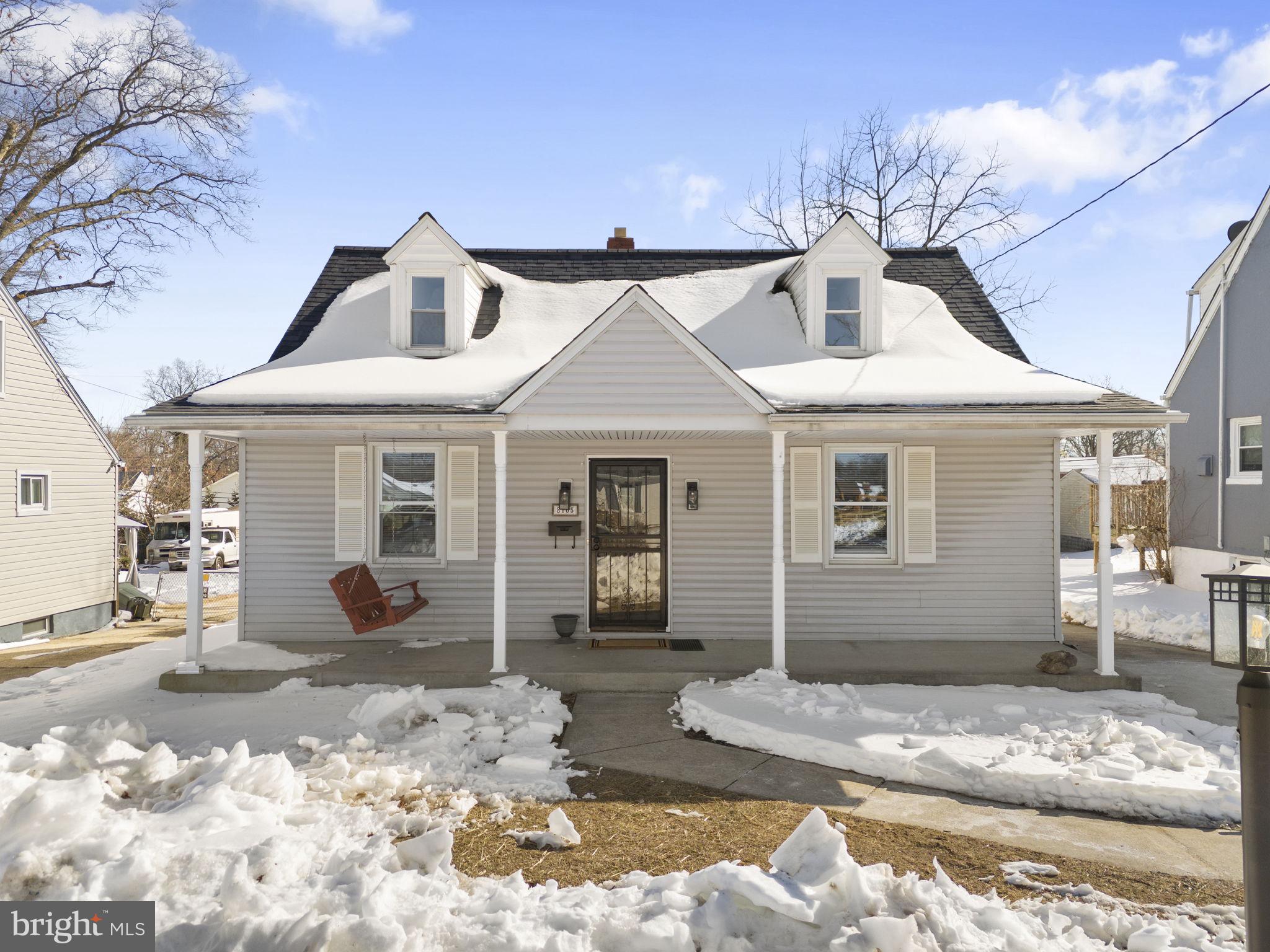 a front view of a house with a yard covered in snow