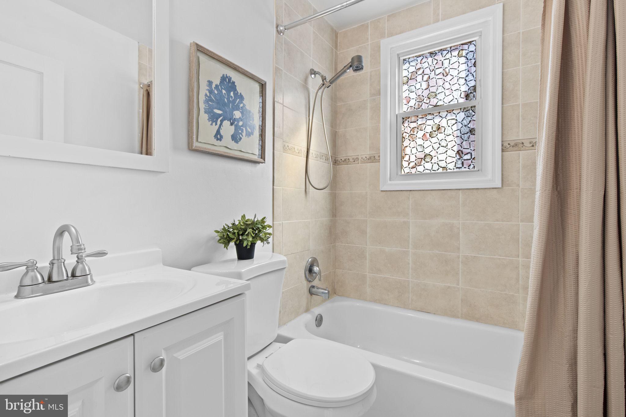 8105 Hillendale Road Baltimore, MD 21234 - Photo 18 of 39 a bathroom with a sink a toilet and a bathtub