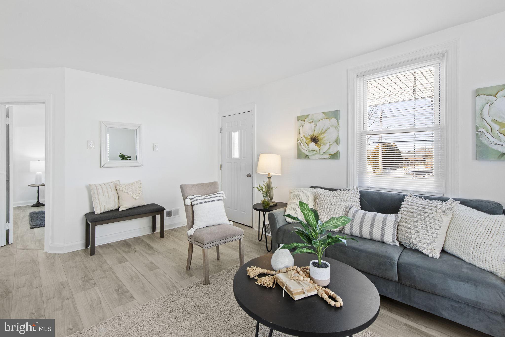 8105 Hillendale Road Baltimore, MD 21234 - Photo 6 of 39 a living room with furniture and a potted plant
