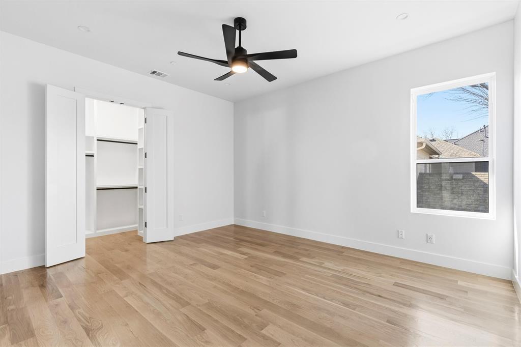 6257 Turner Way Dallas, TX 75230 - Photo 26 of 39 a view of empty room with wooden floor and window