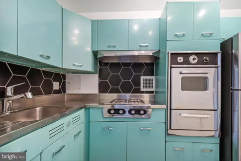 a kitchen with a sink cabinets and a wooden floor