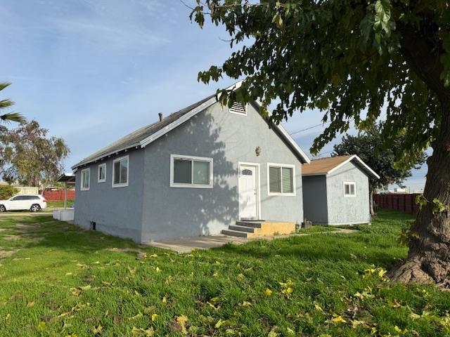 16286 Letteau Avenue Delhi, CA 95315 - Photo 2 of 16 a front view of house with yard and green space