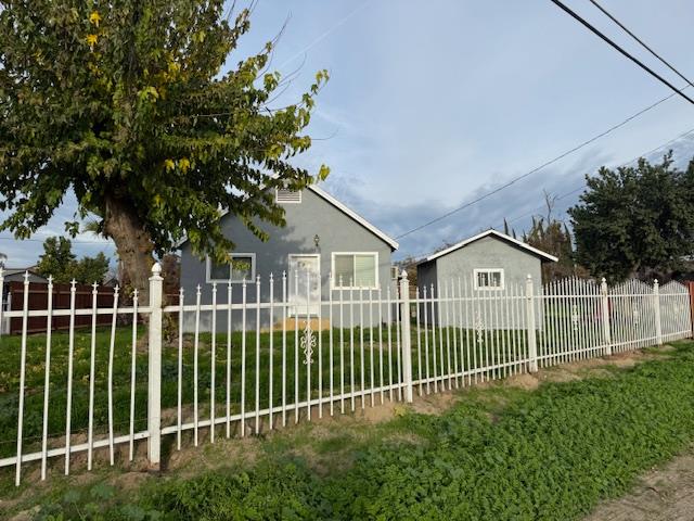16286 Letteau Avenue Delhi, CA 95315 - Photo 3 of 16 a view of a house with a small yard and plants