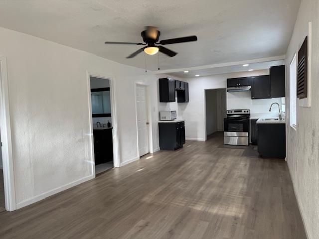 16286 Letteau Avenue Delhi, CA 95315 - Photo 5 of 16 a view of a kitchen with a sink a refrigerator and a stove top oven