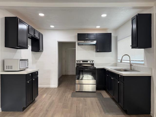 16286 Letteau Avenue Delhi, CA 95315 - Photo 7 of 16 a kitchen with a sink stainless steel appliances and cabinets