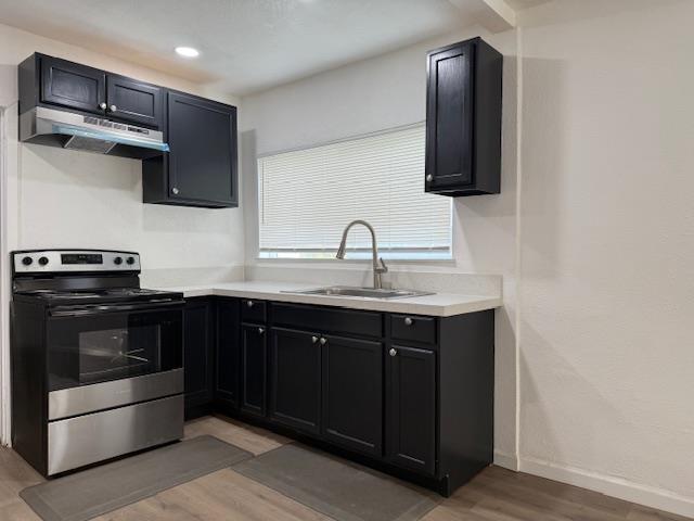 16286 Letteau Avenue Delhi, CA 95315 - Photo 8 of 16 a kitchen with stainless steel appliances granite countertop a sink and a stove