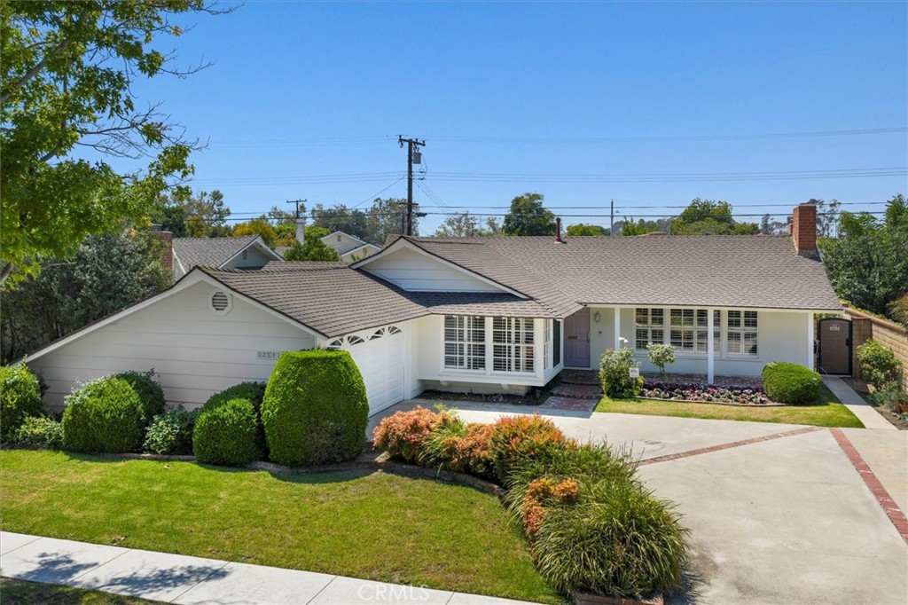 12151 Foster Road Los Alamitos, CA 90720 - Photo 1 of 1 a view of a house with a big yard and potted plants