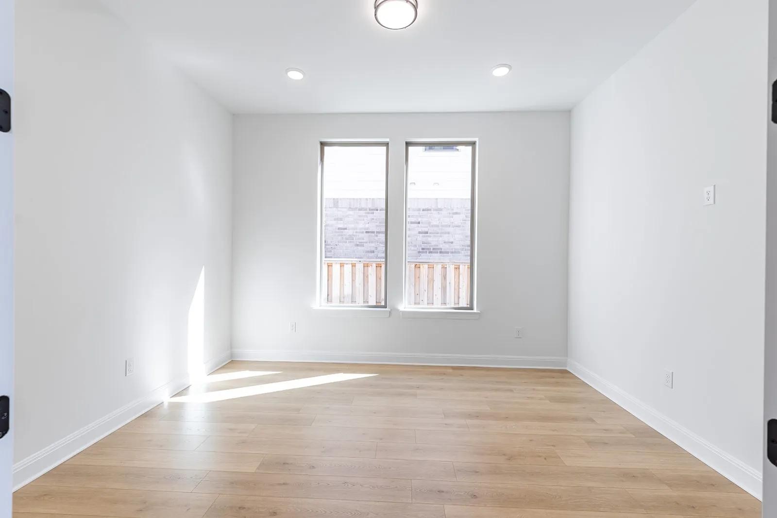 308 Buckaroo Drive Georgetown, TX 78633 - Photo 8 of 31 an empty room with wooden floor and windows