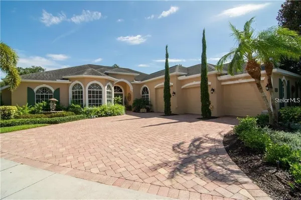 a front view of a house with a garden and pathway