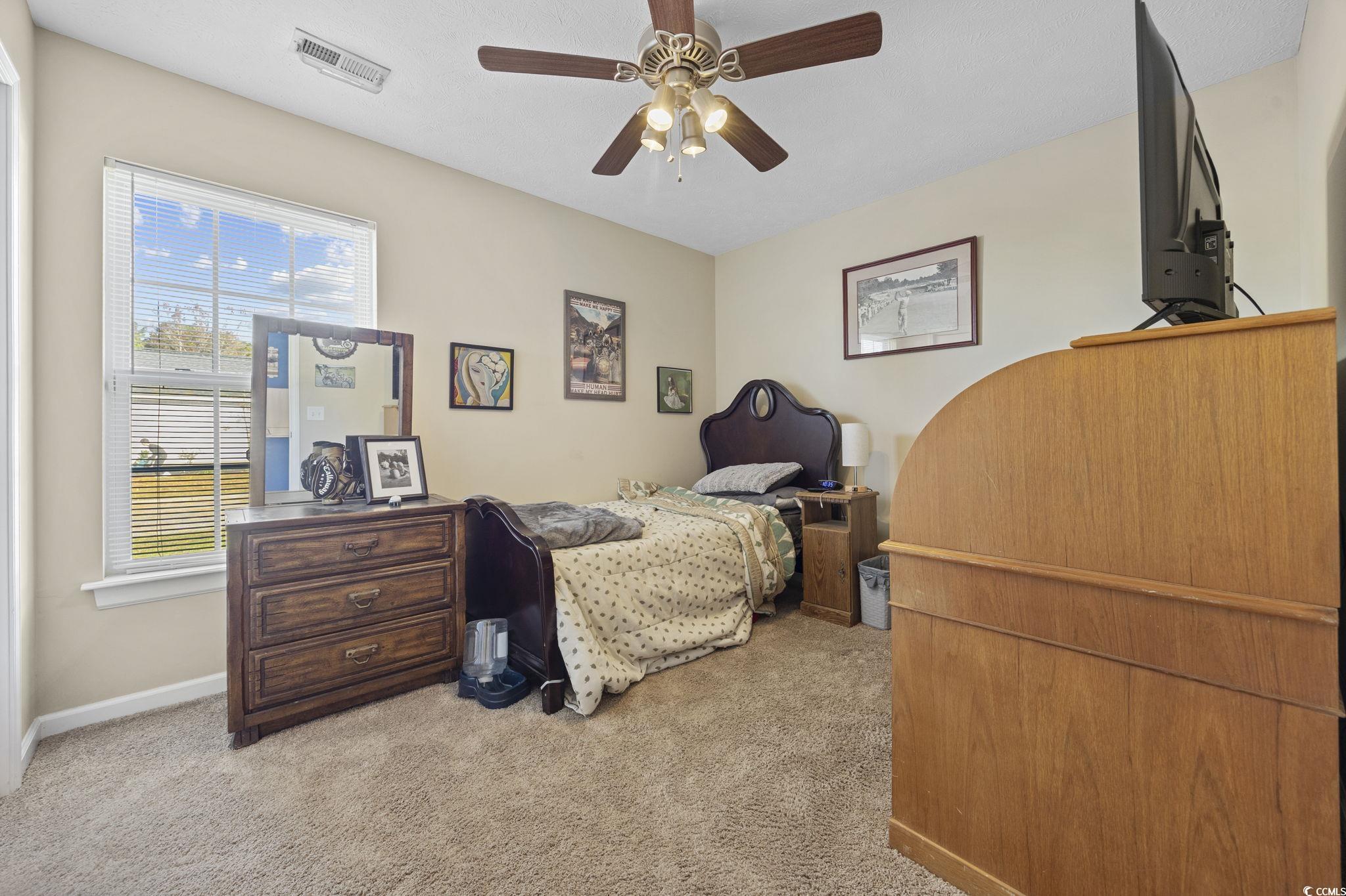 2902 Silverleaf Circle Loris, SC 29569 - Photo 22 of 38 Bedroom featuring light colored carpet and ceiling fan