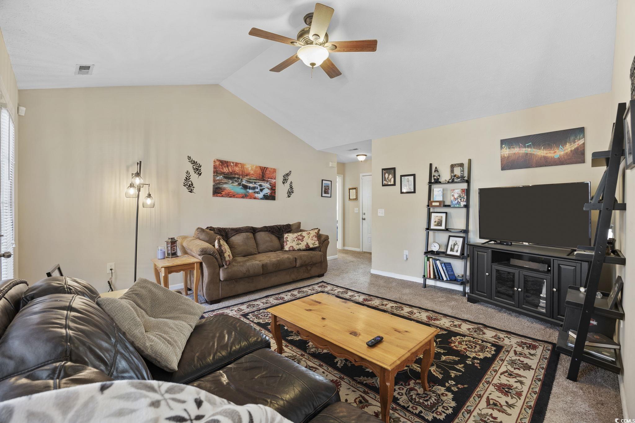 2902 Silverleaf Circle Loris, SC 29569 - Photo 5 of 38 Carpeted living room with lofted ceiling and a ceiling fan