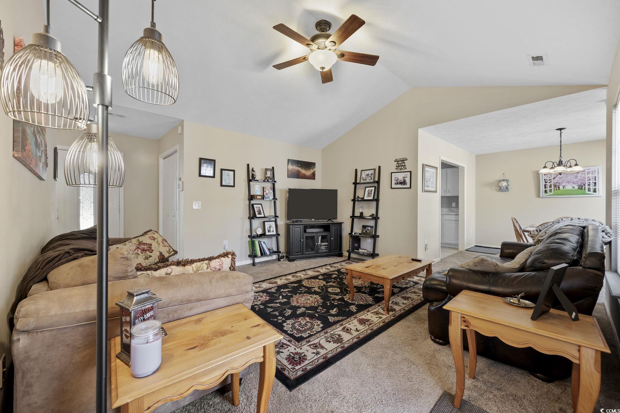 2902 Silverleaf Circle Loris, SC 29569 - Photo 6 of 38 Carpeted living area with ceiling fan and vaulted ceiling