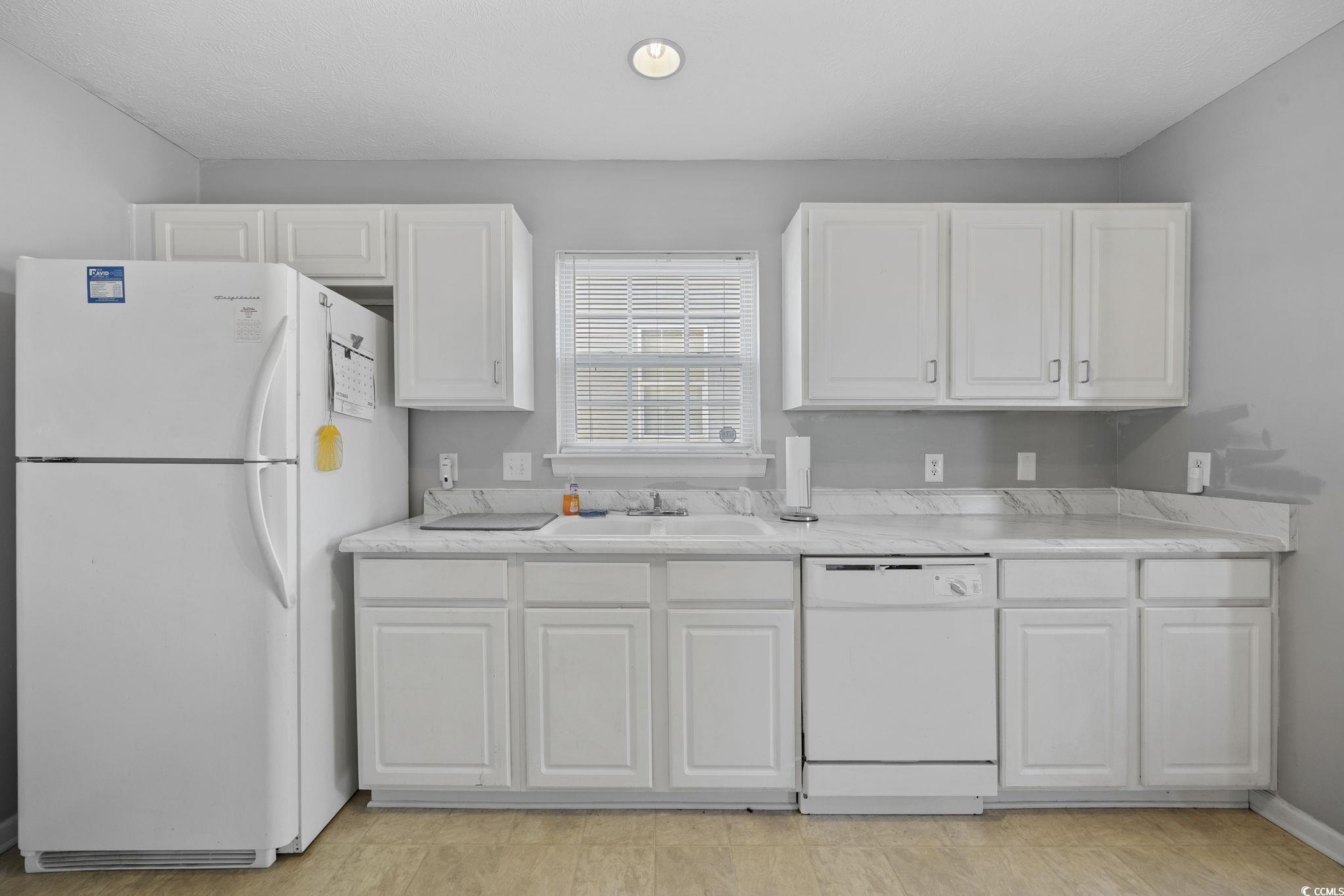 2902 Silverleaf Circle Loris, SC 29569 - Photo 9 of 38 Kitchen with white appliances, light countertops, white cabinetry, and recessed lighting