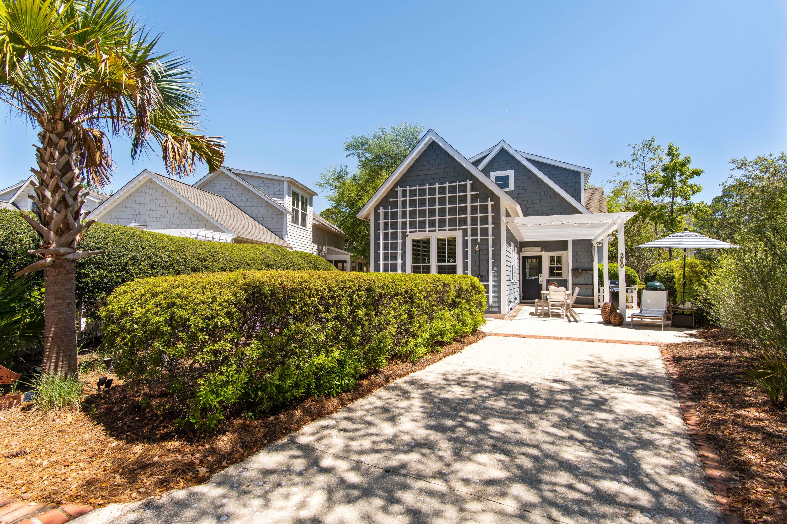 260 Salt Inlet Beach Inlet Beach, FL 32461 - Photo 30 of 39 a front view of a house with a yard and potted plants