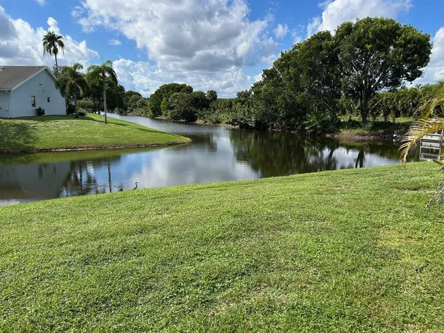 a view of a lake with a house in the background