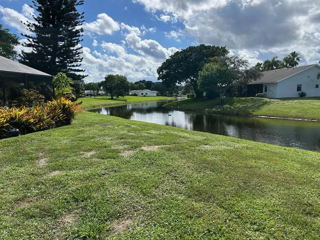 a view of a lake with a house in the background
