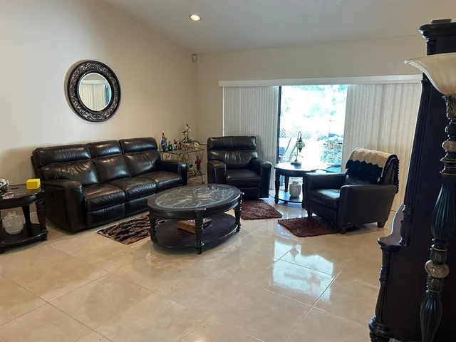 a living room with furniture a window and a fireplace